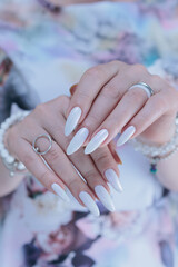 beautiful female hands with long nails light white manicure