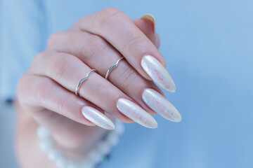 beautiful female hands with long nails light white manicure