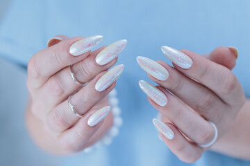 beautiful female hands with long nails light white manicure