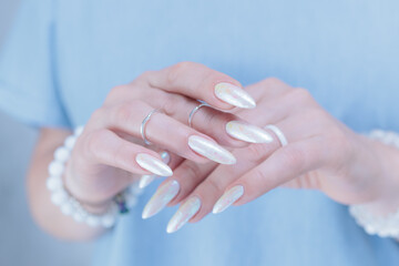 beautiful female hands with long nails light white manicure