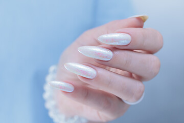 beautiful female hands with long nails light white manicure