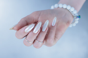 beautiful female hands with long nails light white manicure