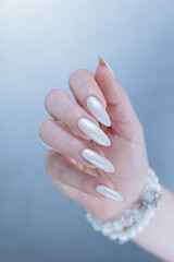 beautiful female hands with long nails light white manicure