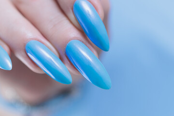 beautiful hand with long nails and light baby blue manicure	