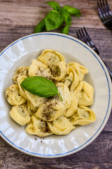 Home made Italian   Tortelloni  bolognese with  parmesan cheese filled with  beef ,  tomato and mozzarella cheese, decorated with fresh basil