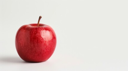 A bright red apple on a pristine white background, with room for text