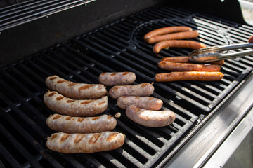 Grilling sausages on a barbecue grill. Selective focus.