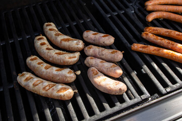 Grilling sausages on a barbecue grill. Selective focus.