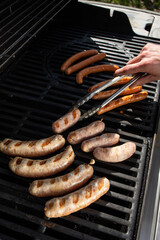 Grilling sausages on a barbecue grill. Selective focus.