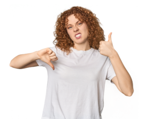 Young Caucasian redhead woman showing thumbs up and thumbs down, difficult choose concept