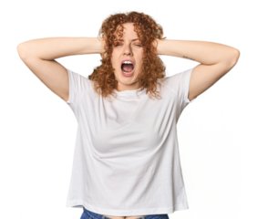 Young Caucasian redhead woman covering ears with hands trying not to hear too loud sound.