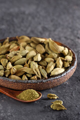 organic cardamom spice in bowl on table