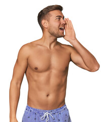 Naklejka premium Young man shirtless in swimwear, studio shouting and holding palm near opened mouth.