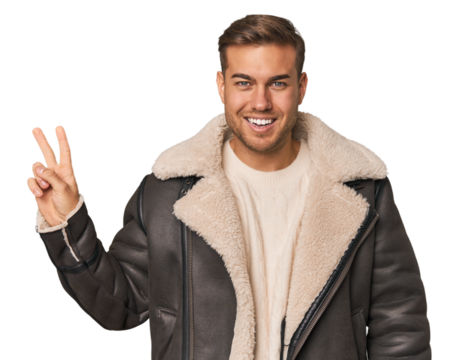 Young caucasian man joyful and carefree showing a peace symbol with fingers. - Powered by Adobe