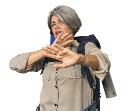 Caucasian mid-age female with hiking gear being shocked due to an imminent danger