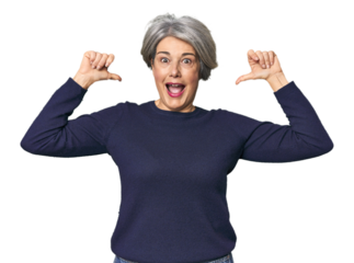 Caucasian mid-age female on studio background feels proud and self confident, example to follow.