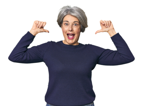 Caucasian mid-age female on studio background feels proud and self confident, example to follow.