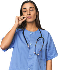 Hispanic nurse in uniform with stethoscope with fingers on lips keeping a secret.