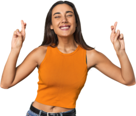 Hispanic young woman crossing fingers for having luck