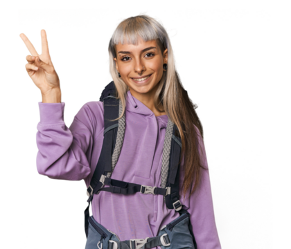 Young caucasian woman ready to hike joyful and carefree showing a peace symbol with fingers.