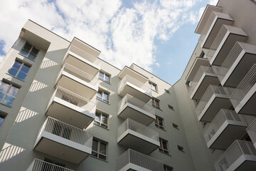 Modern apartment building against a clear blue sky. Residential building architecture. Urban real estate. New build block of flats. Modern living neighbourhood. Real estate market in Europe background