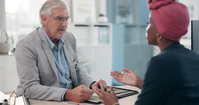 Mature businessman, woman and interview in office with candidate, inclusion and FAQ in company. Recruitment, male CEO and discussion at desk for negotiation, equal opportunity and integration