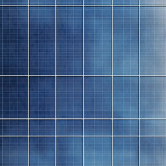 A close-up view of solar panel cells arranged in a grid pattern, showcasing their blue hues and intricate design.