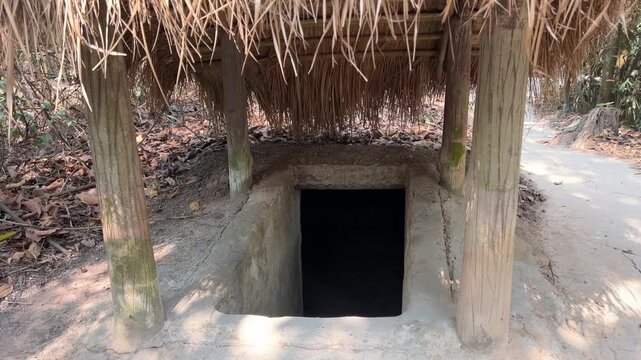dungeon entrance tunnel camouflaged Cu Chi tunnels were the Viet Cong's base of operations for the Tet Offensive in 1968. Famous tourist attraction in Vietnam