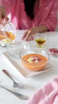 Girl Serving Salmorejo with Boiled Egg and Ham