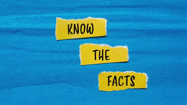 Know the facts message writing on ripped yellow torn paper pieces on blue background