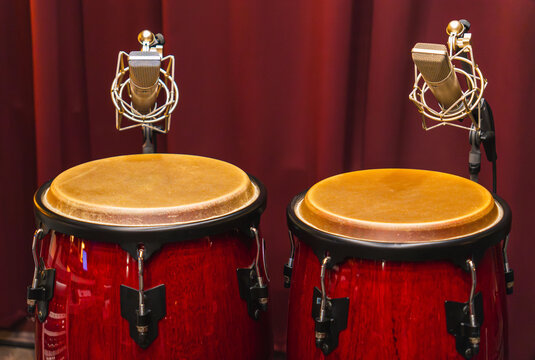 conga drums in recording studio with microphones