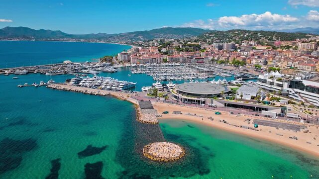 Aerial view of Cannes Port on Cote d'Azur, France. View from above of Marina port with ships and yachts in a resort town on the French Riviera, famed for its international film festival.