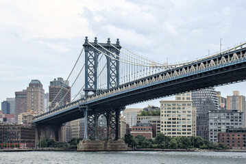 manhattan bridge detail (downtown lower east side view looking towards brooklyn with hudson river) famous landmark with tall buildings skyline background famous new york city travel destination nyc