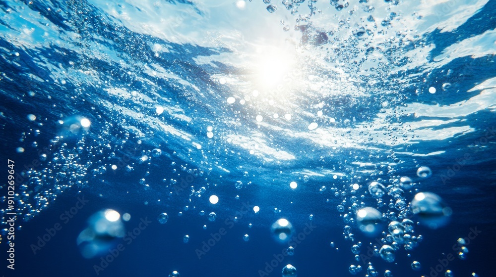 Poster underwater view with bubbles rising to the surface, illuminated by sunlight, creating a serene blue 