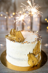 Spiced Pear Cake with vanilla cream, golden pear slices, star sprinkles, and burning sparklers