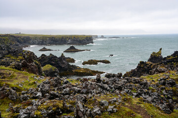 Basaltic cliffs at the shore of Iceland with waves and rough seas