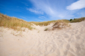 Sand dunes landscape against cloud blue sky