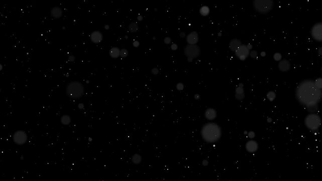dust particals flying against black background 4k