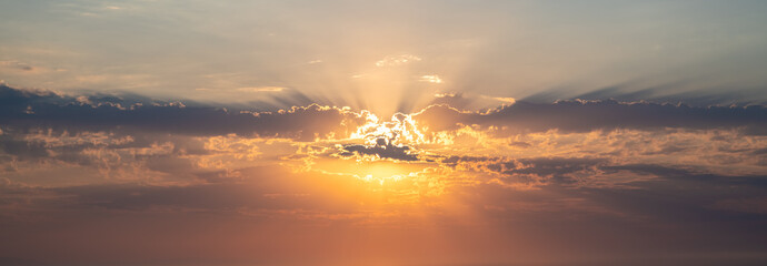 Beautiful sunset or sunrise, sky with clouds, sun rays breaking through the clouds, magical, fabulous natural background, serenity and calm