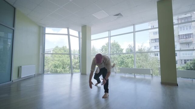 Stylish young man dancing break dance and choreography. Performance, movement, style and fashion concept