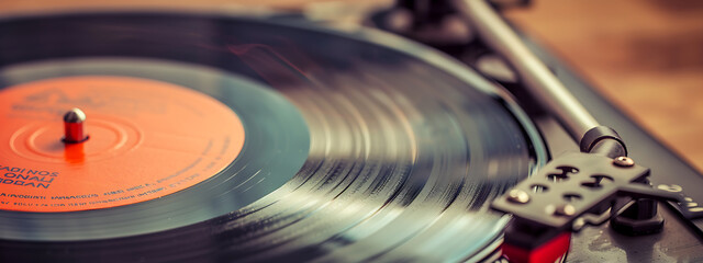 Vintage black and orange record player spinning a vinyl record, evoking nostalgia and a love for music. 
