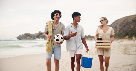 Friends, walking and talking by sea on holiday, picnic and bonding together on adventure by ocean shore. Men, woman and diversity with foot on sand, happy and cooler box with drinks for beach party - Powered by Adobe