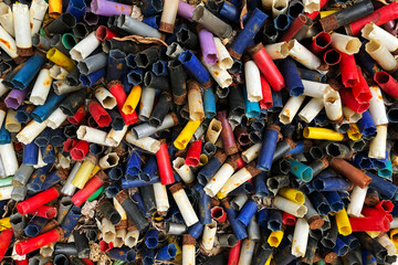 Fototapeta premium Shotgun cartridges abstract background piled up at a shooting ground having been shot at clay pigeon targets 