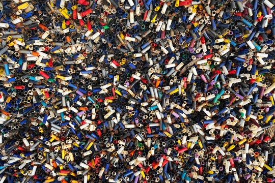 Shotgun cartridges abstract background piled up at a shooting ground having been shot at clay pigeon targets