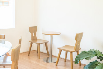 Empty wooden chairs and table in dining room,tropical plants and elegant personal accessories in stylish home decor,Template..