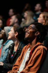 Fototapeta premium Group of people watching a movie in cinema. Men and women with excited expressions on their faces.