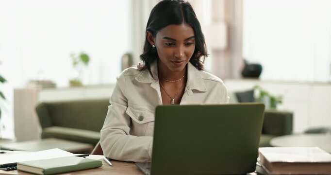 Laptop, Indian woman and home for online, typing or remote work from living room with computer. Lounge, smile or internet for language transcriber, technology or website for freelance female person