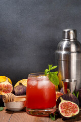 Iced figs leIced figs lemonade cocktail, autumn fruit cold drink with fig juice, mint, lemon and honey, sweet and tasty autumn party alcohol beveragemonade cocktail