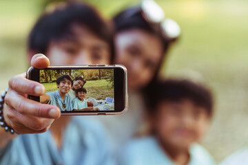 Asian family enjoying a sunny day picnic outdoors
