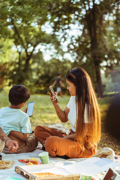 Asian family enjoying a sunny picnic in the park